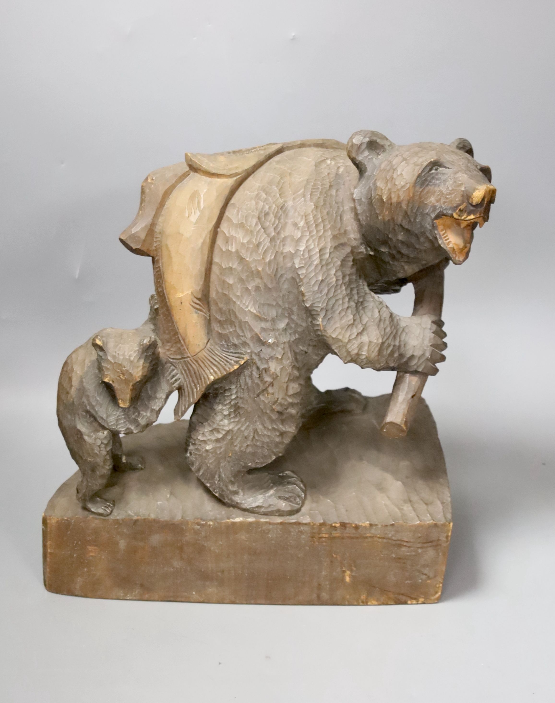 A carved wood fishing bear group 30cm